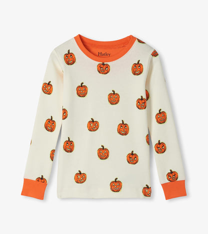 Kids pajama top in cream with orange jack-o'-lantern print and orange neck and sleeve cuffs