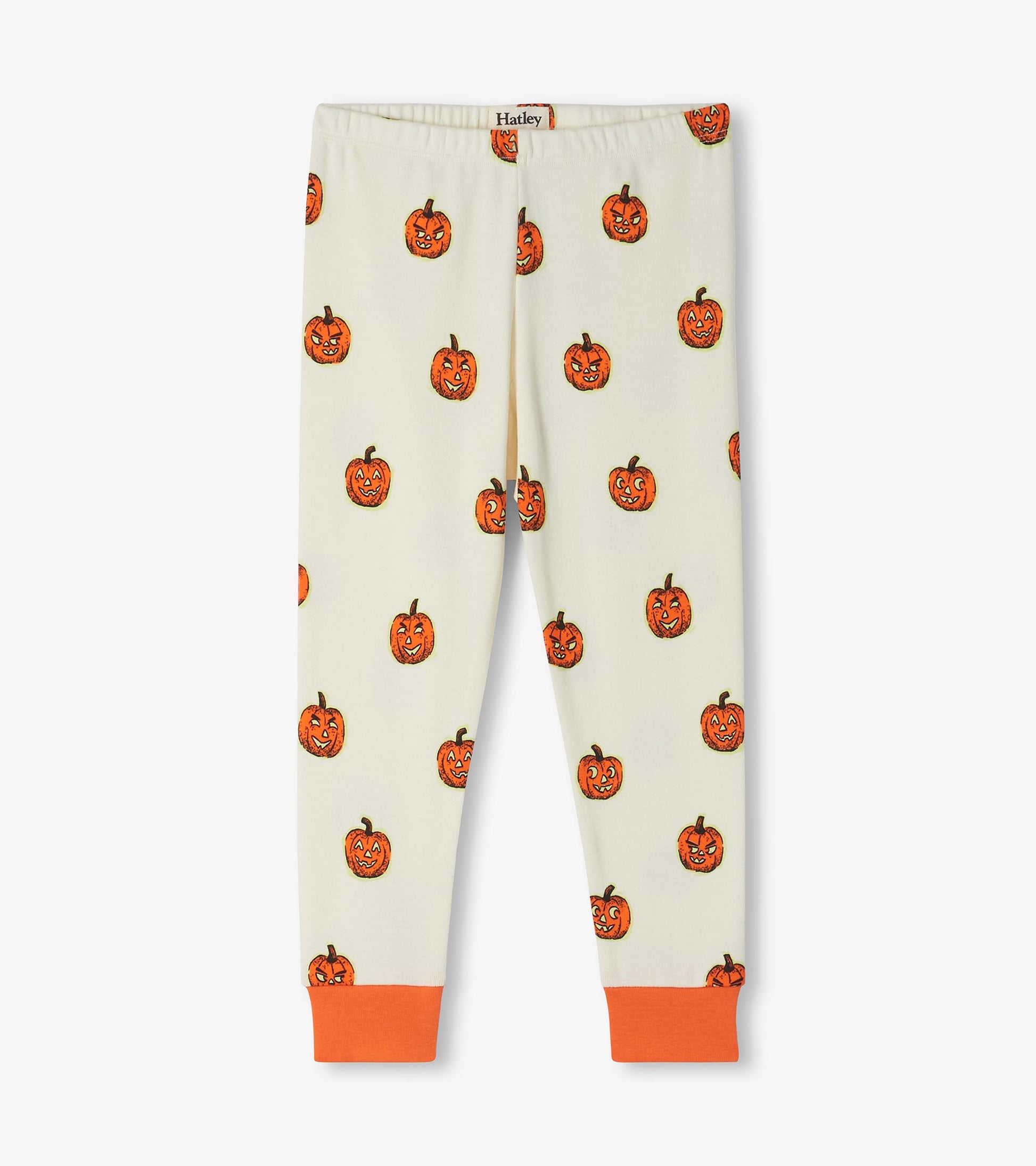 Kids pajama pants in cream with orange jack-o'-lantern print and orange ankle cuffs
