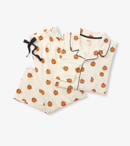 Folded cream pumpkin print pajama set with black piping on the shirt and black drawstring on the pants