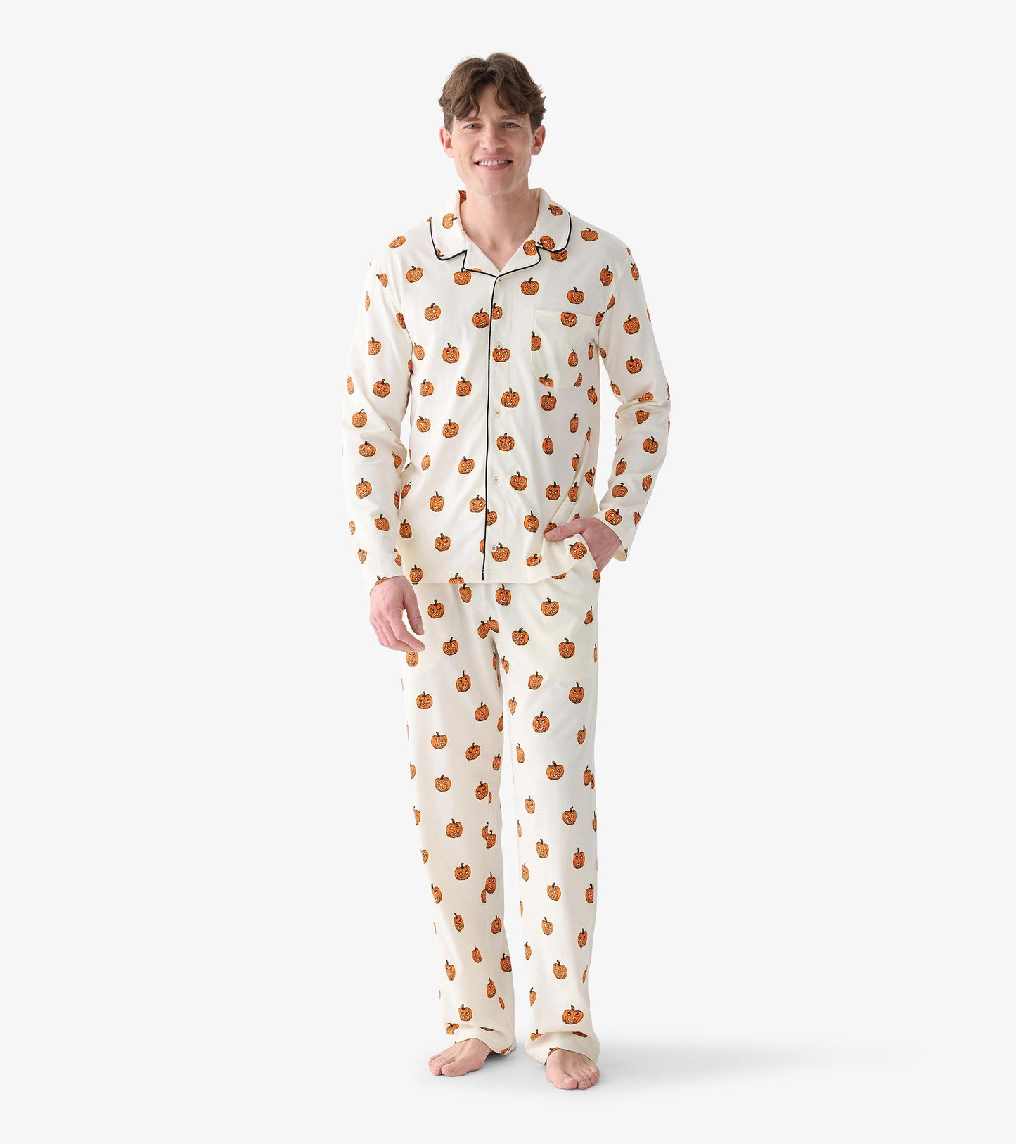 Front view of men's cream pumpkin print pajama set with black piping, chest pocket, and matching pants