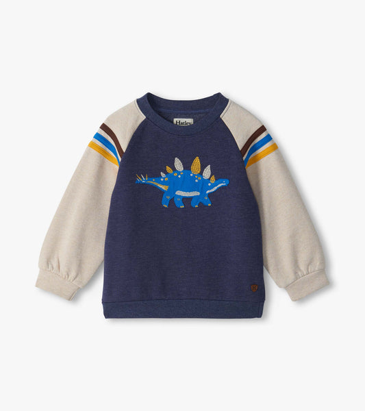 Kids pullover sweatshirt with navy body, cream sleeves, striped shoulders, and blue stegosaurus graphic