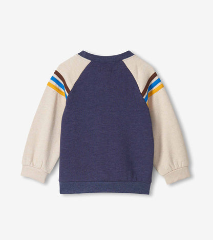 Back view of navy pullover sweatshirt with oatmeal raglan sleeves and blue, white, yellow, and brown shoulder stripes