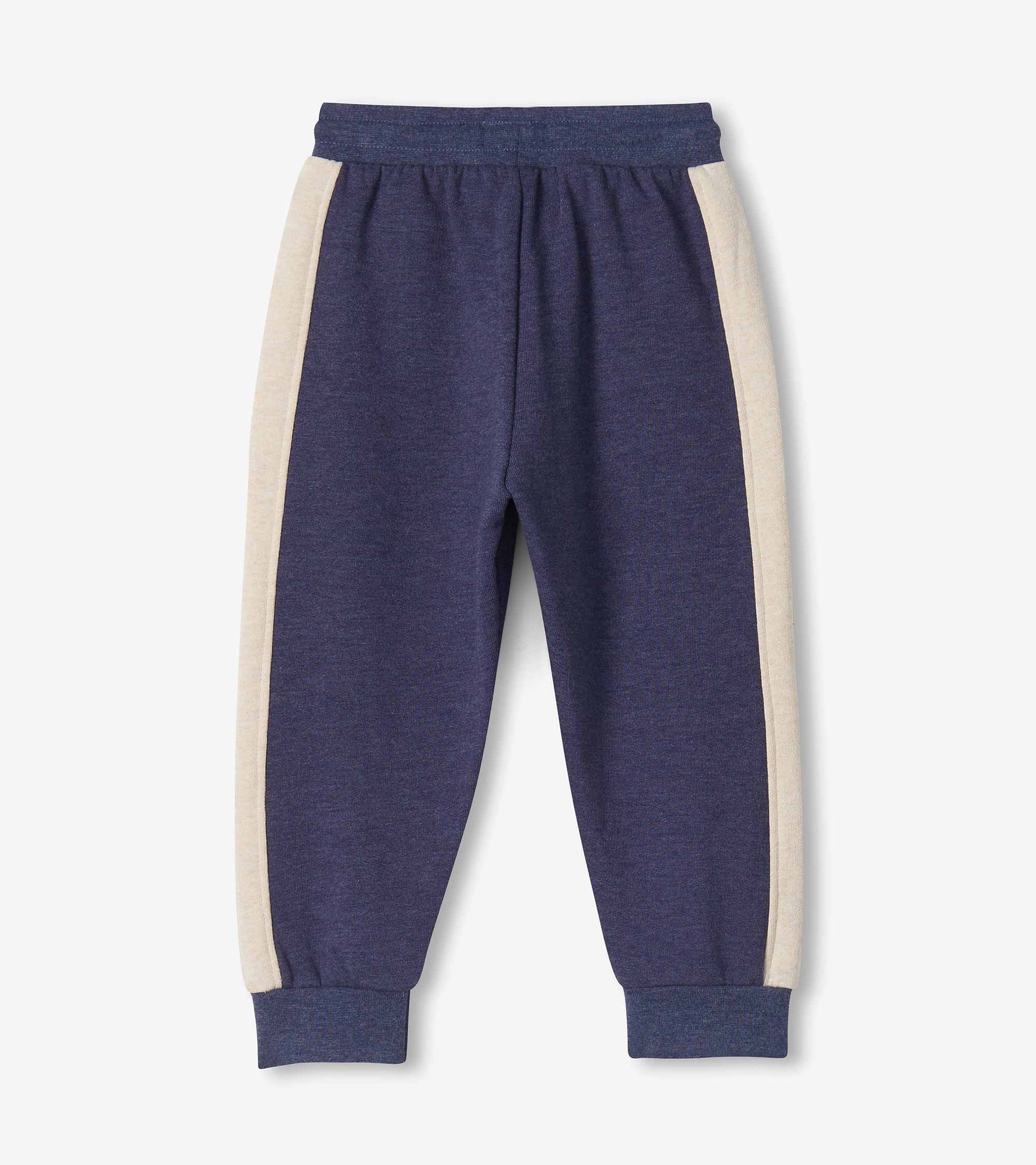 Back view of blue melange track pants with oatmeal side panels and ribbed cuffs