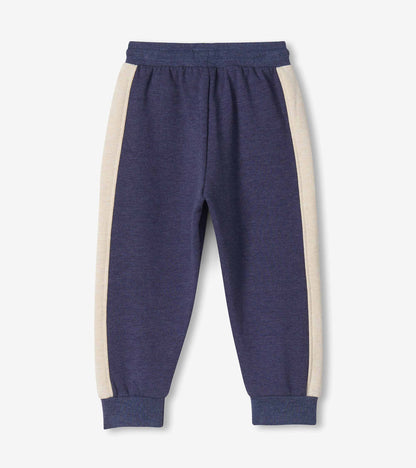 Back view of blue melange track pants with oatmeal side panels and ribbed cuffs
