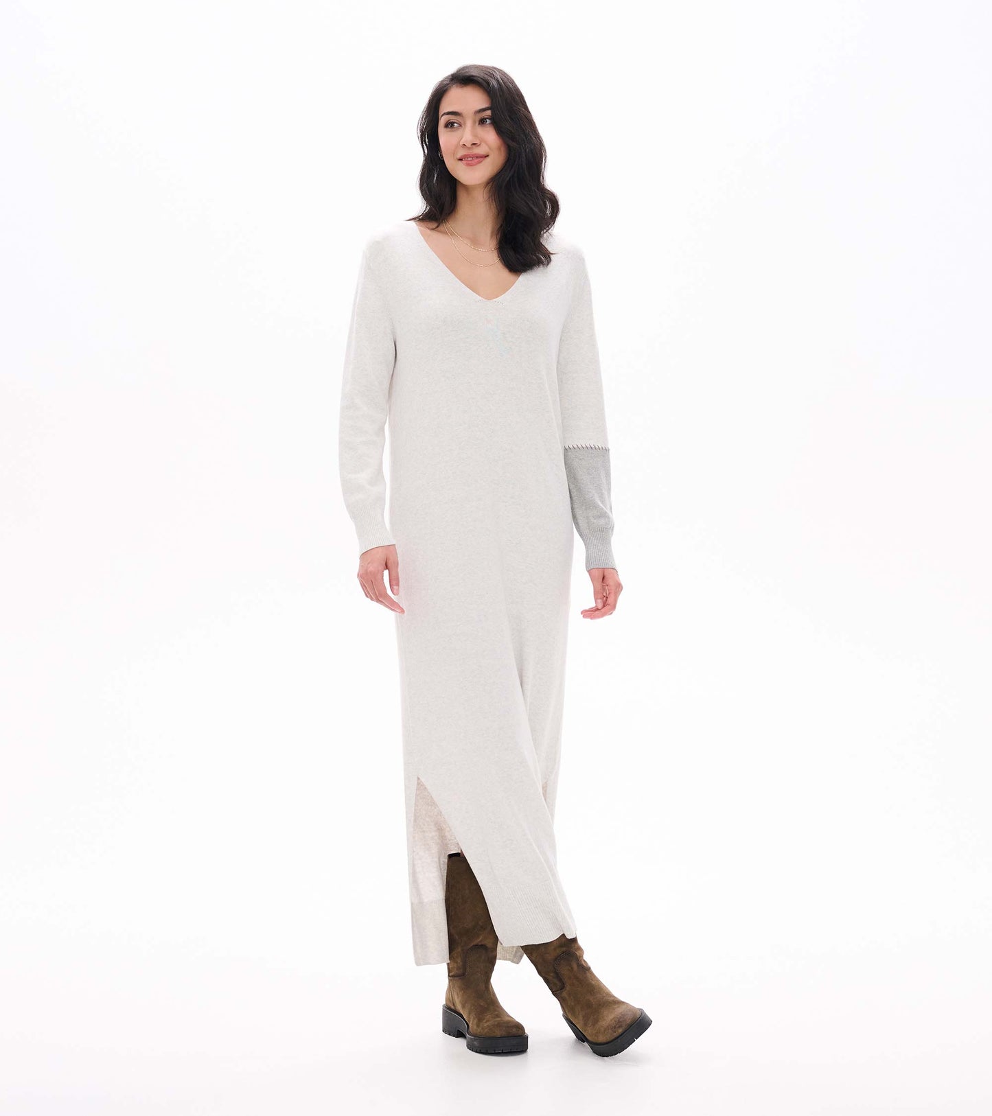Three-quarter front view of pale grey melange maxi sweater dress with side slit and contrast sleeve detail
