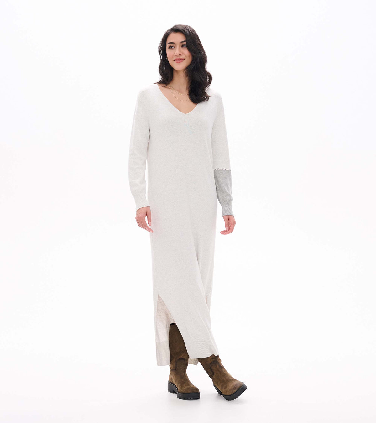 Three-quarter front view of pale grey melange maxi sweater dress with side slit and contrast sleeve detail