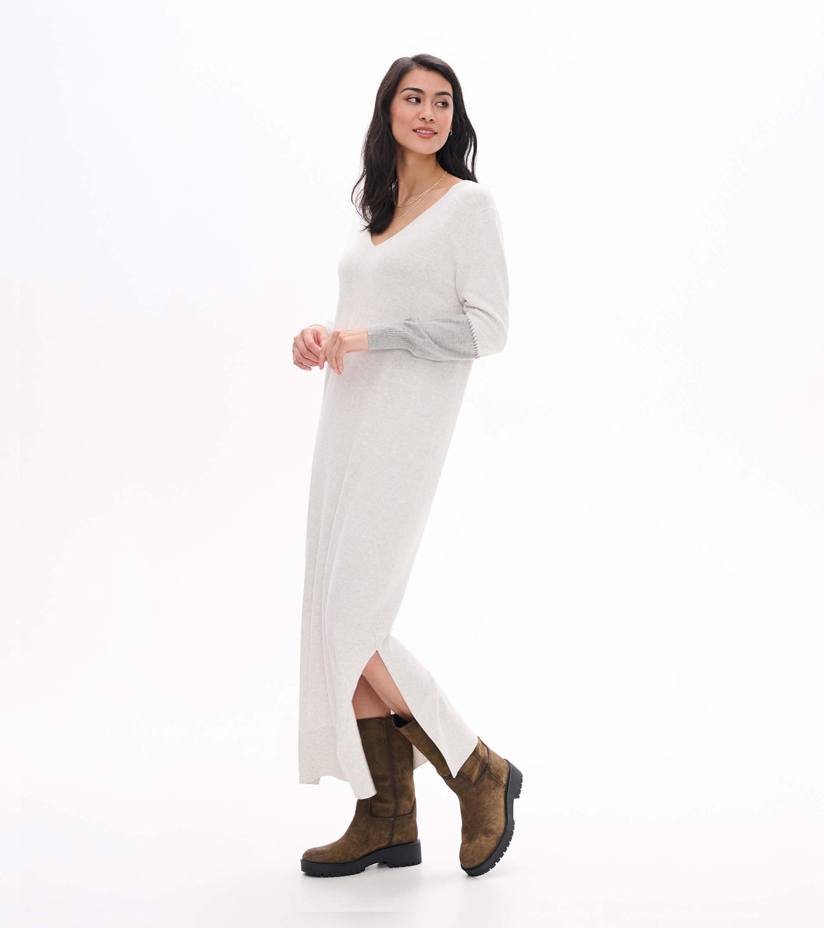 Side view of pale grey melange maxi sweater dress with V-neck, side slit, and contrast sleeve panel