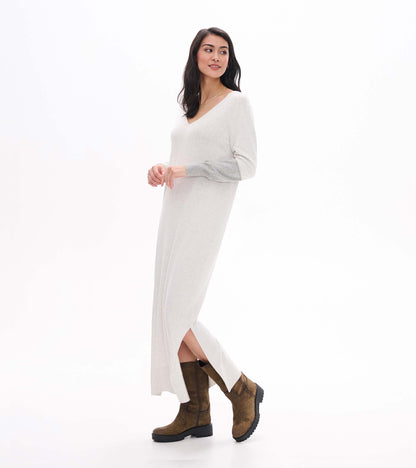 Side view of pale grey melange maxi sweater dress with V-neck, side slit, and contrast sleeve panel
