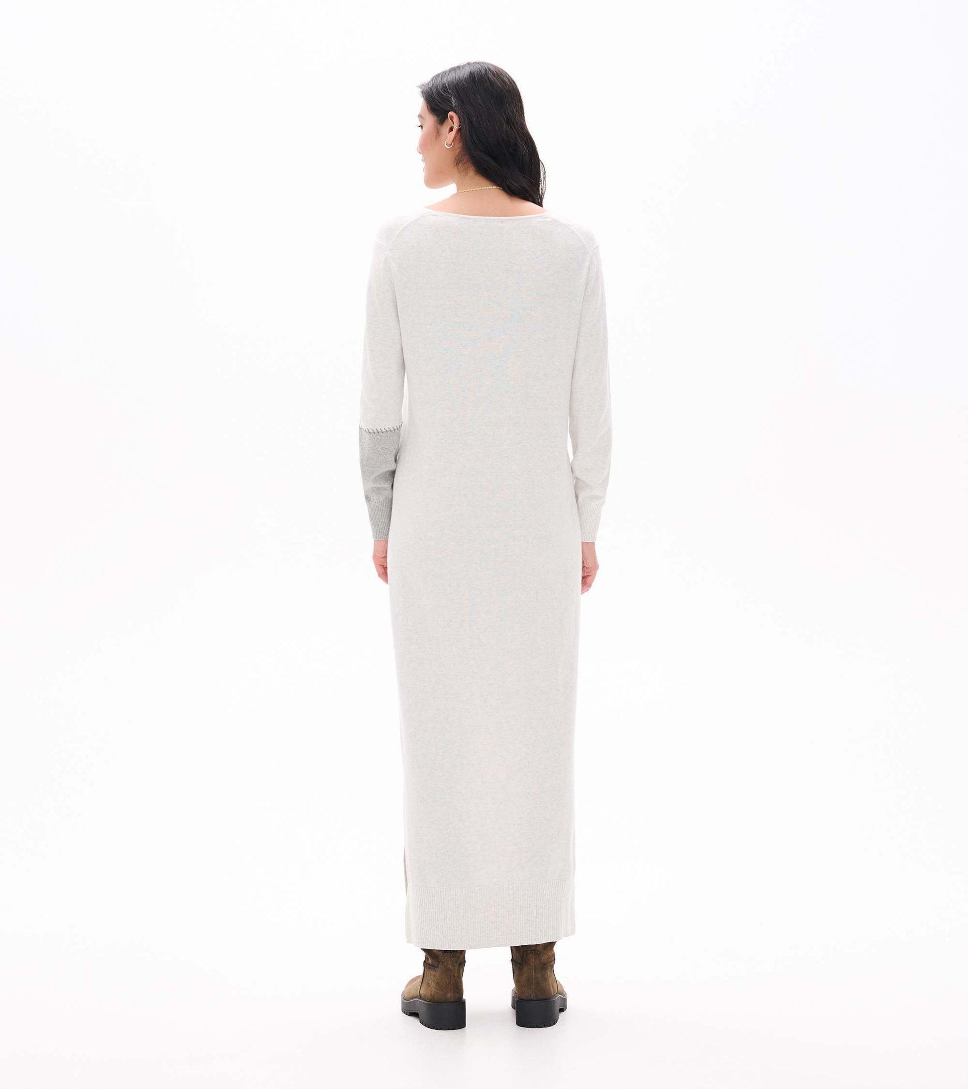 Back view of pale grey melange maxi sweater dress with long sleeves and contrast right sleeve detail