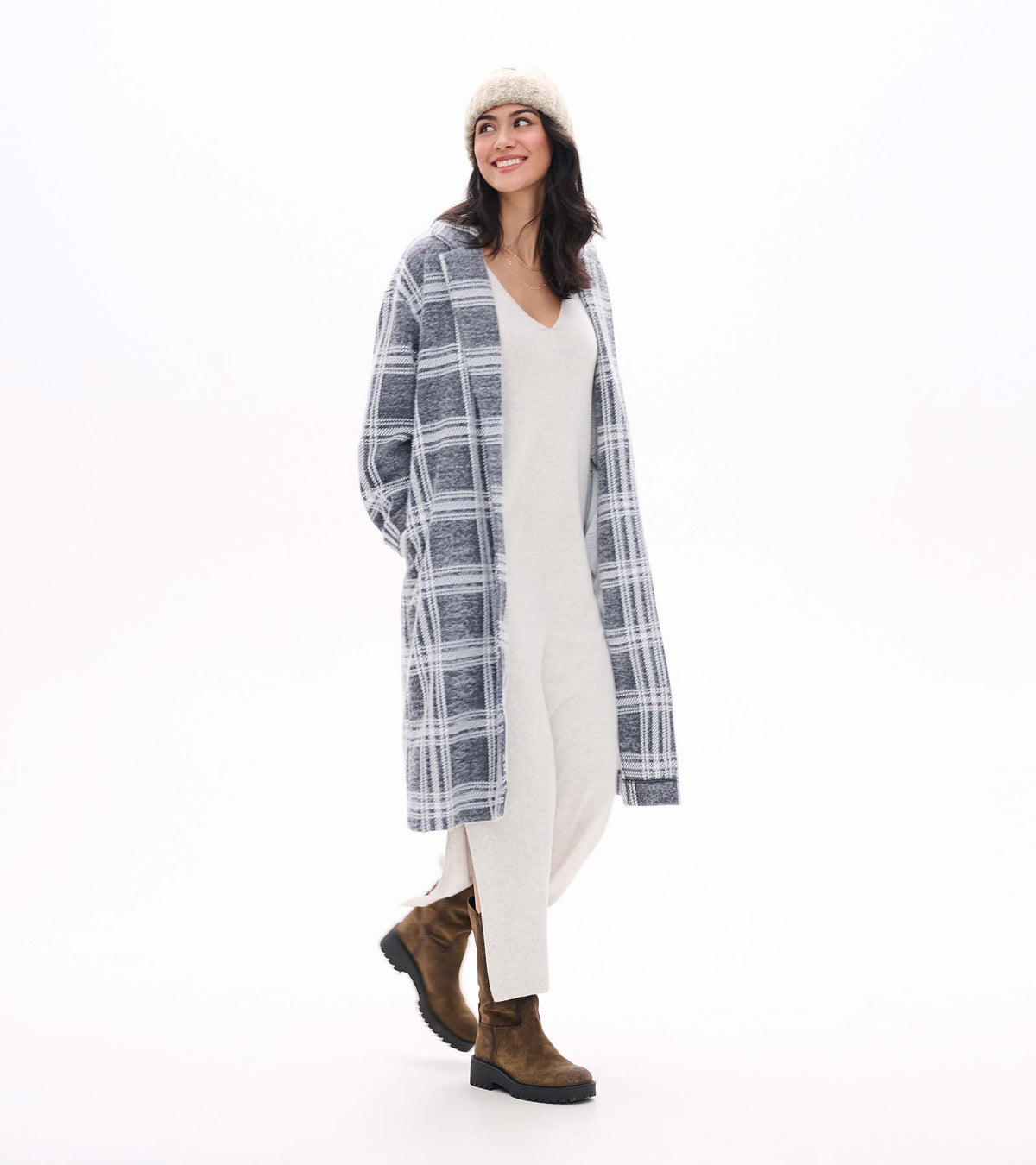 Pale grey melange sweater dress with V-neck and side slit, shown under a grey plaid coat