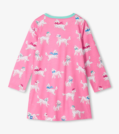 Back view of girls pink nightdress with white poodle print, teal neckline, and long sleeves