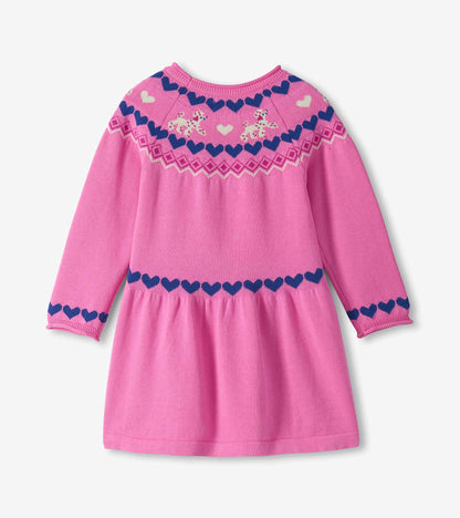 Back view of bright pink sweater dress with long sleeves, gathered skirt, navy hearts and cream puppy yoke