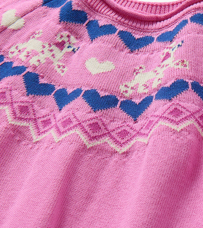Close-up of pink knit yoke with navy hearts, cream hearts and puppy motifs
