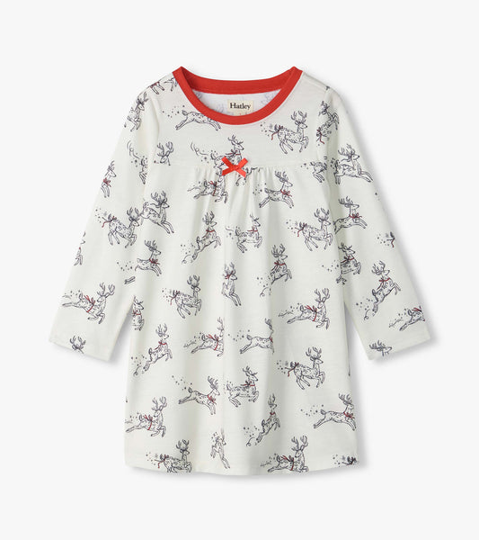 Girls white long-sleeve nightdress with leaping reindeer print, red neckline, and small red bow at the chest