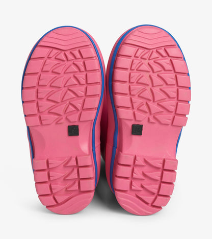 Bottom view of pink kids' boots showing textured tread soles