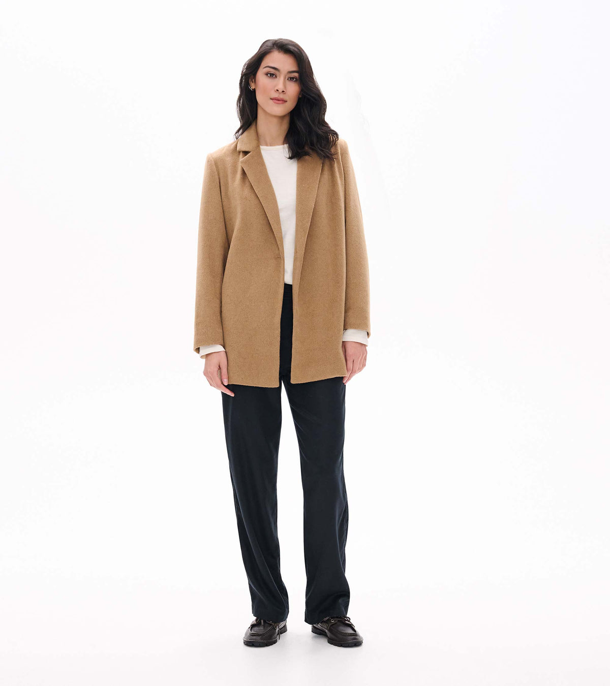Front view of burro brown open jacket styled with white top and black pants on model