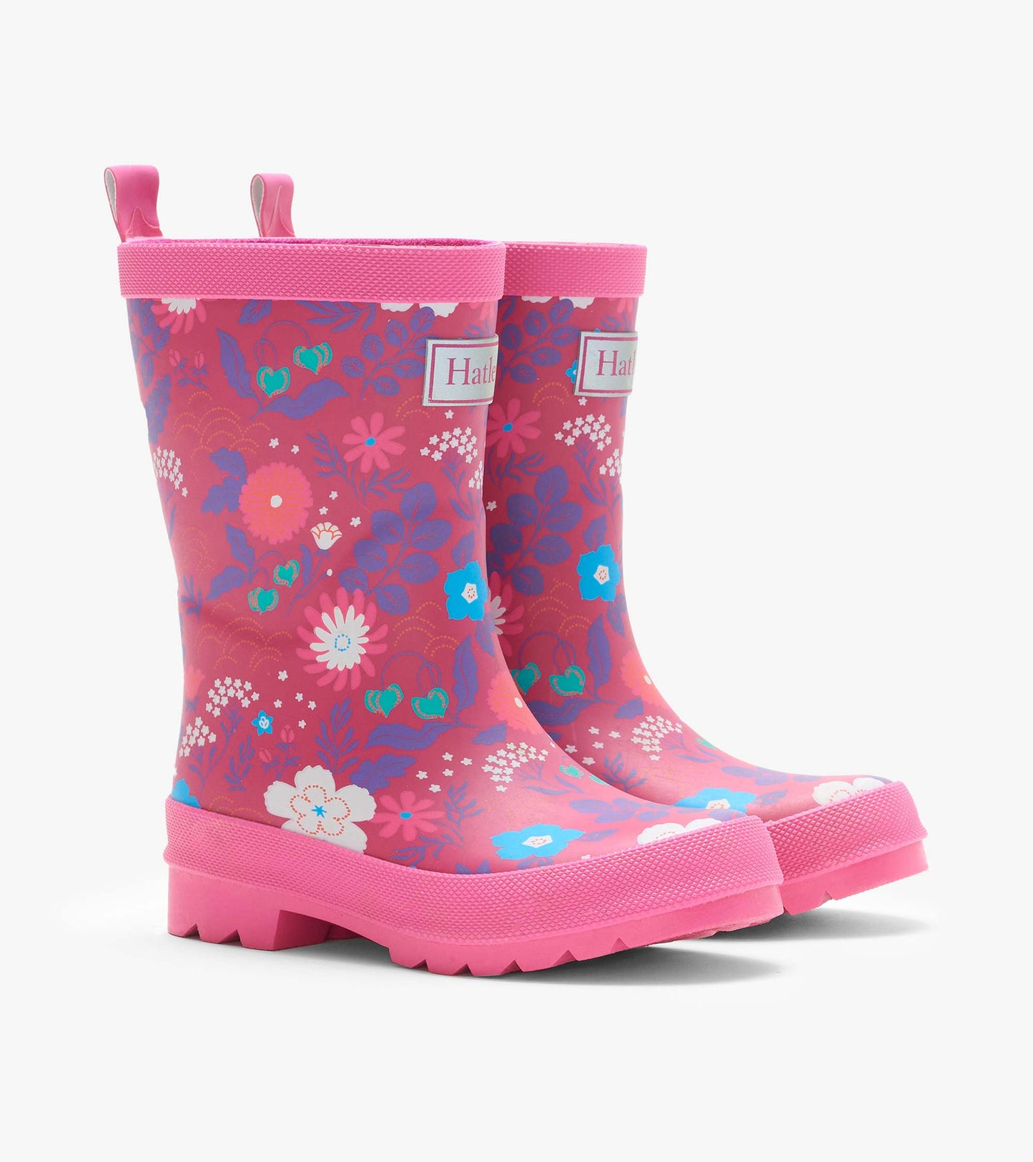 Pair of pink kids rain boots with multicolor floral print, lug soles, and pull tabs