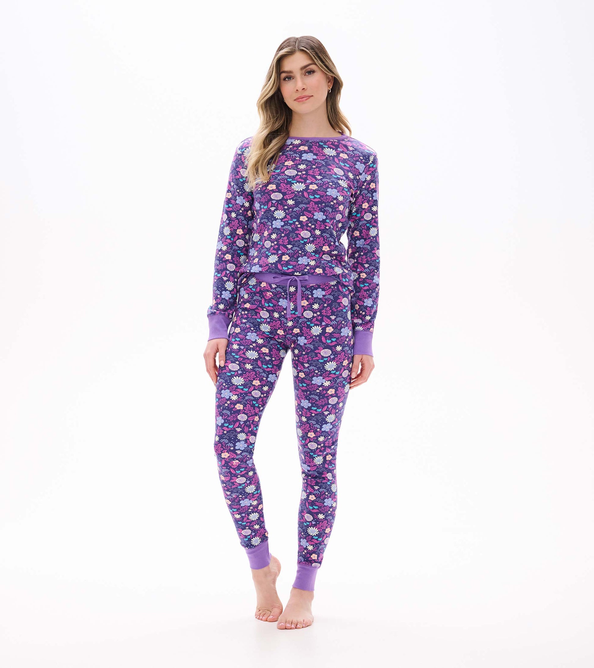 Front view of women's purple floral pajama set with long sleeve top, drawstring waist, and cuffed ankles