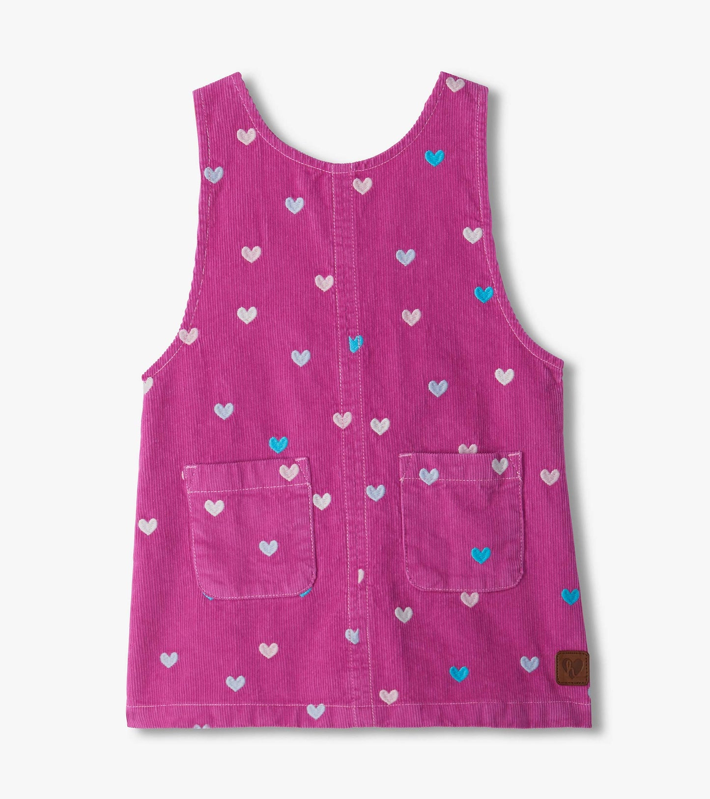 Front view of pink pinafore dress with embroidered hearts, patch pockets, and a sleeveless scoop neck