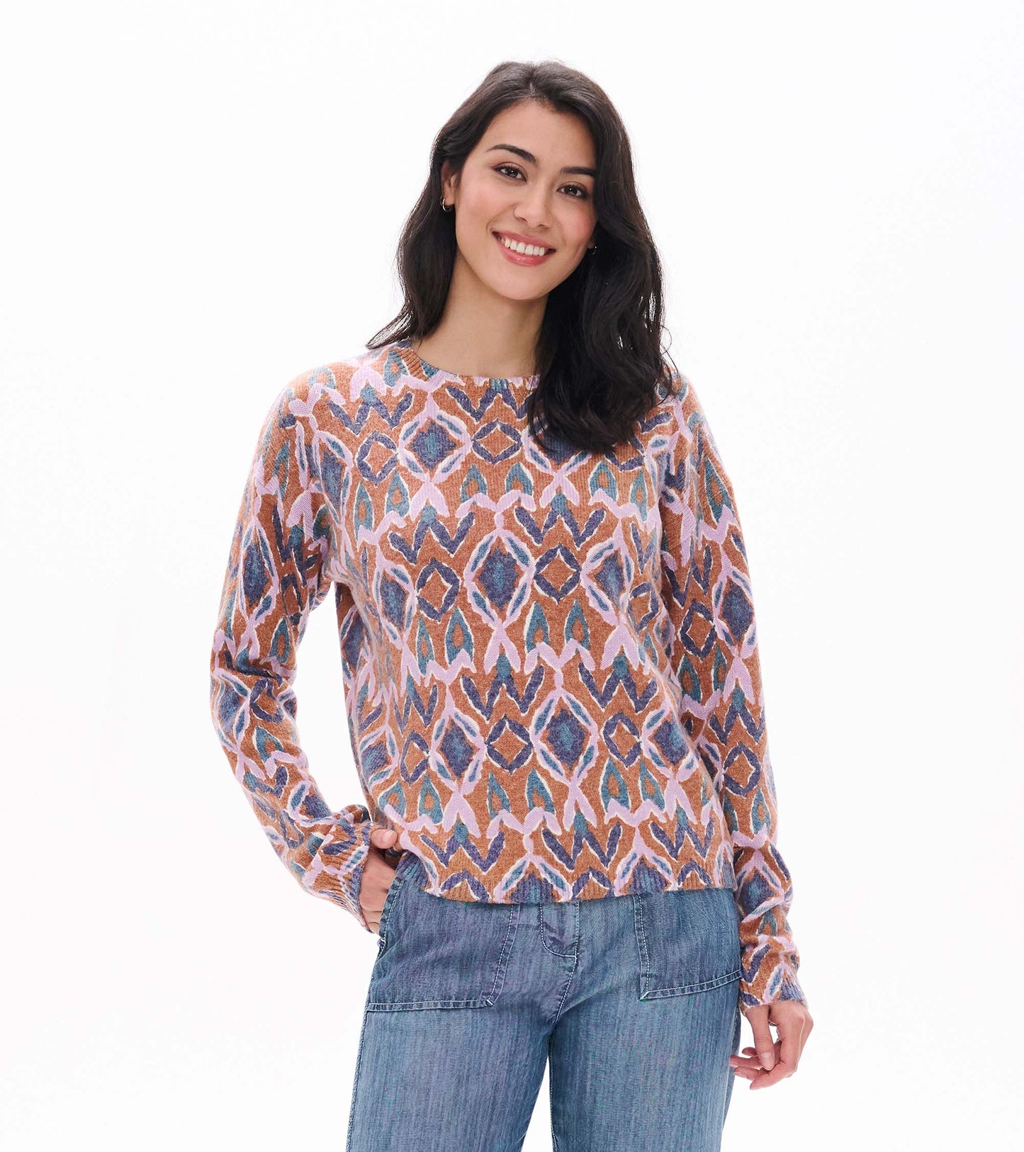Front view of Noa sweater with pink, brown, blue and teal ikat pattern and crew neckline