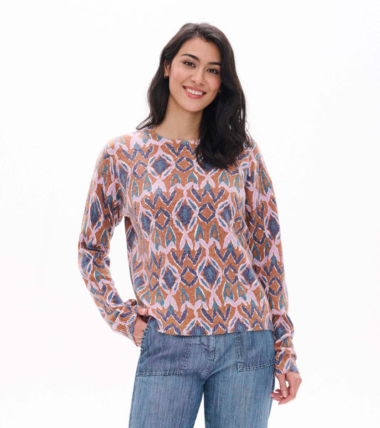 Front view of Noa sweater with pink, brown, blue and teal ikat pattern and crew neckline