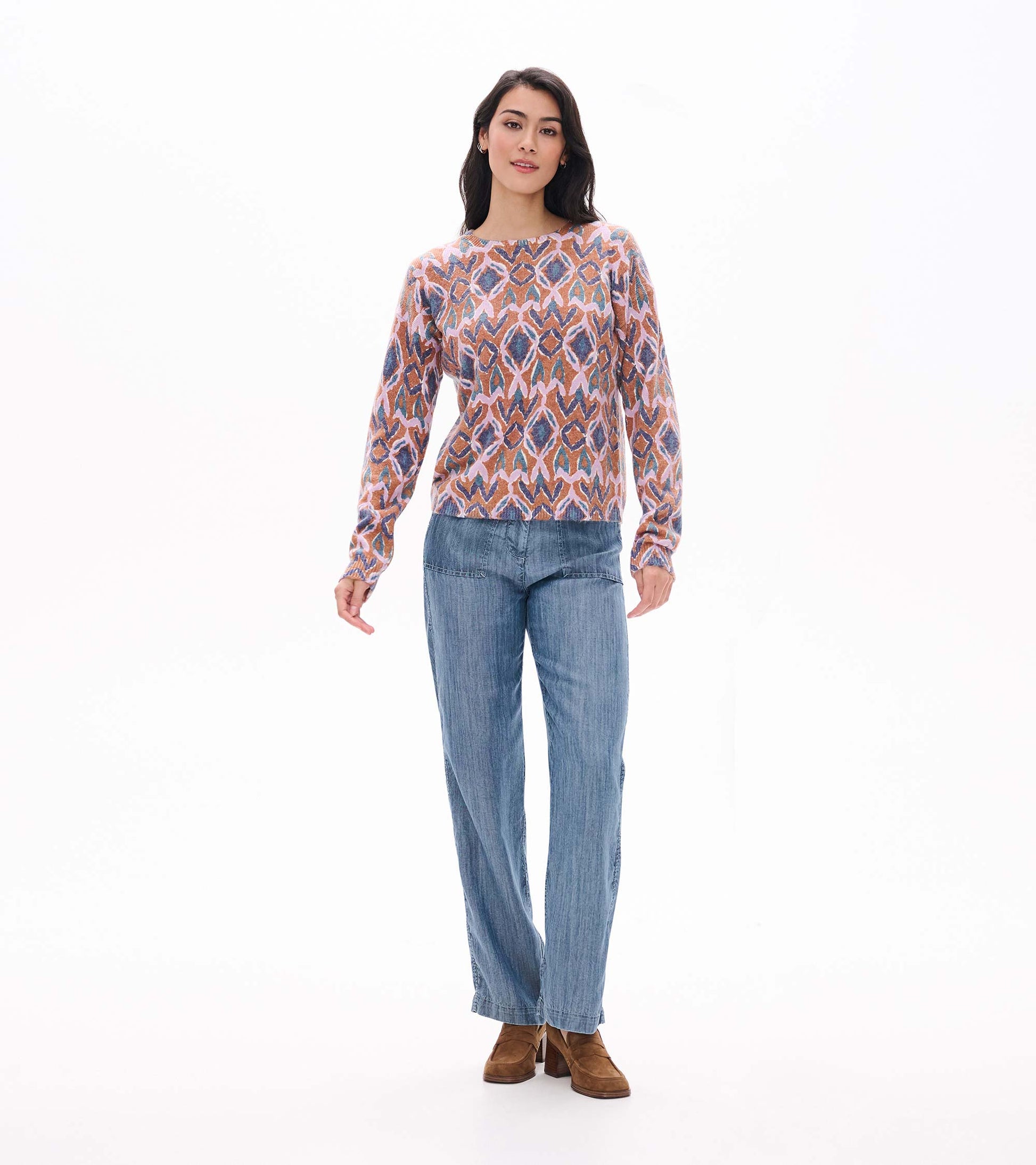 Full front view of Noa sweater with long sleeves and pink, brown, blue and teal ikat pattern