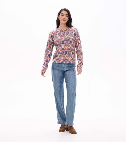 Full front view of Noa sweater with long sleeves and pink, brown, blue and teal ikat pattern