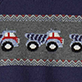 Blue knit pattern with red and white tractors and geometric stripes