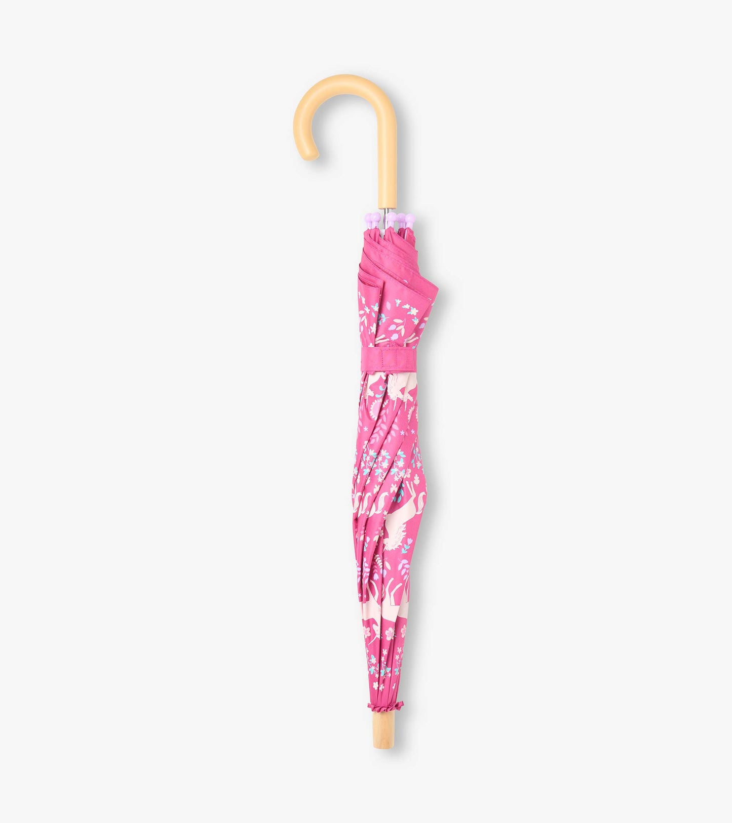 Closed pink umbrella with white unicorn print, hook handle, and matching strap