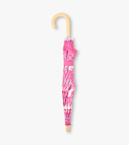 Closed pink umbrella with white unicorn print, hook handle, and matching strap