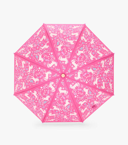 Top view of pink umbrella canopy with white unicorns and scattered flowers