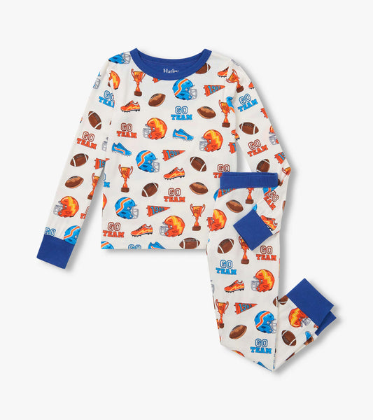 Kids pajama set with blue trim and football print featuring helmets, trophies, shoes, pennants, and 'Go Team