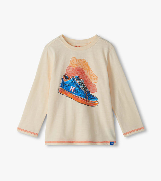 Cream long sleeve crew neck tee with colorful sneaker graphic on the front