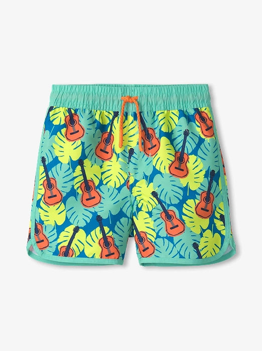 Promotes kids swim sale collection. Showing turquoise boys swim shorts with tropical leaf and guitar print.