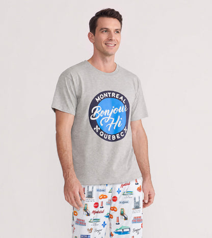 Man wearing a heather gray Bonjour Hi T-shirt with a blue Montreal Quebec graphic, shown with printed pajama pants