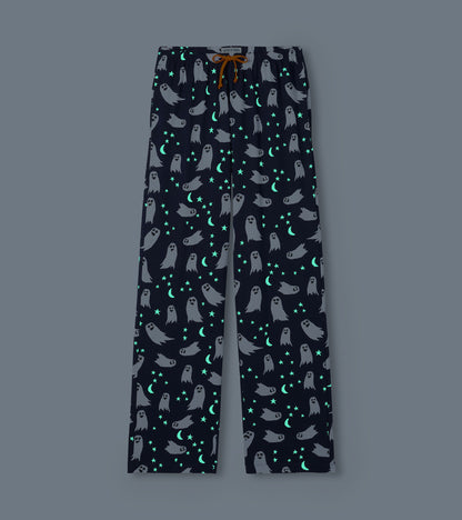 Navy ghost-print pajama pants with glowing stars and crescent moons on a dark background