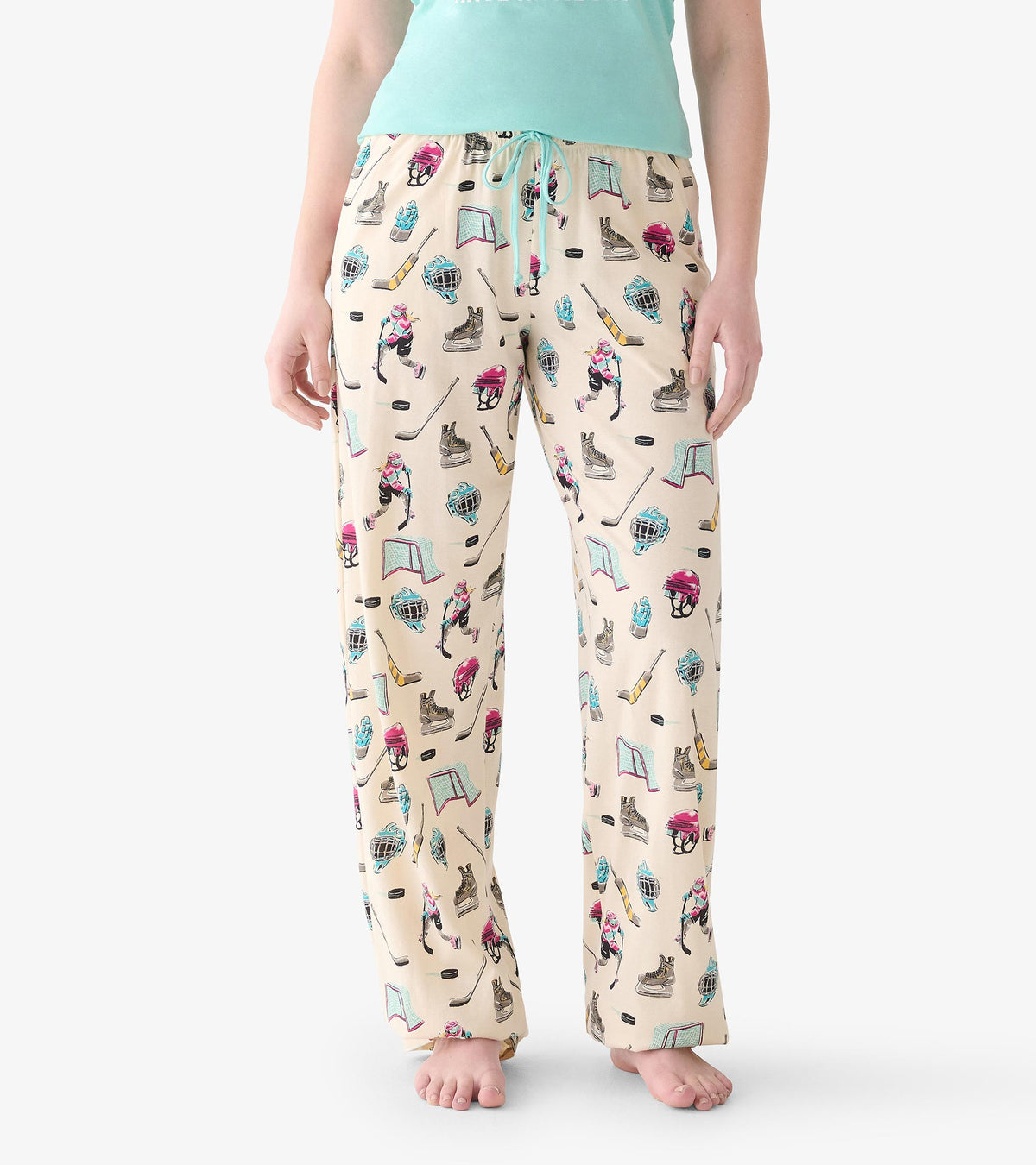 Close view of women's pajama pants with hockey print and aqua drawstring waist