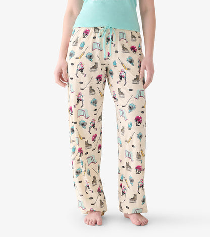 Close view of women's pajama pants with hockey print and aqua drawstring waist
