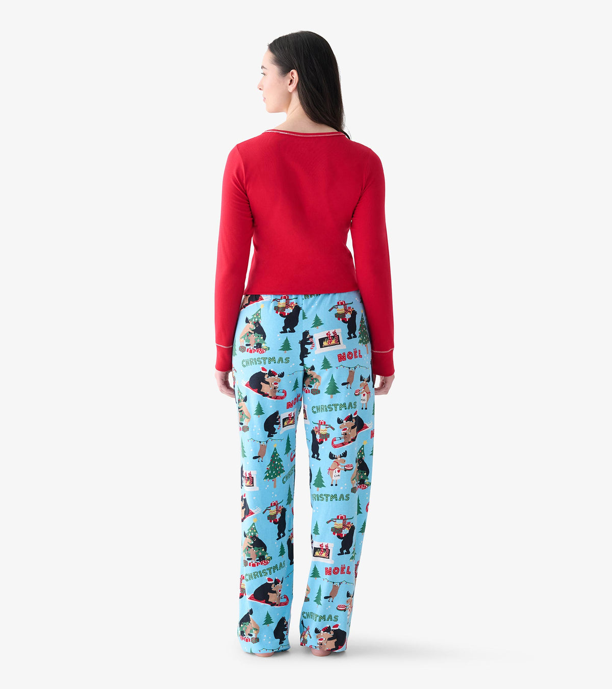 Back view of women's light blue Christmas pajama pants with bears, moose, trees, and holiday scenes