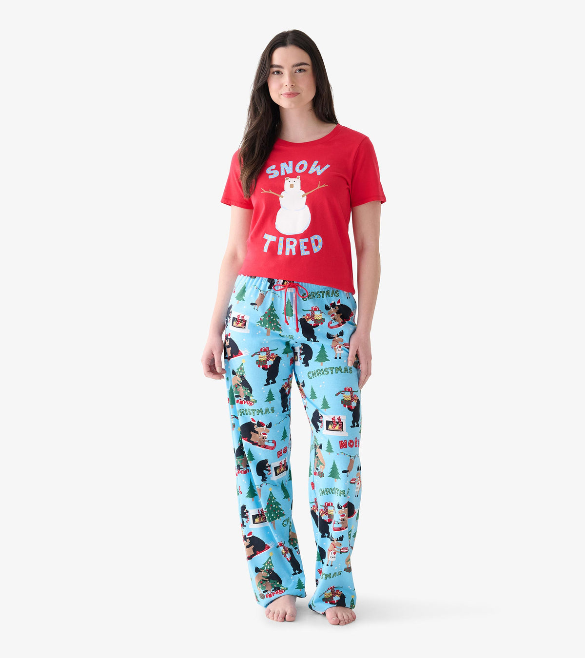 Women's light blue Christmas pajama pants shown with red graphic tee, featuring bears, moose, and trees