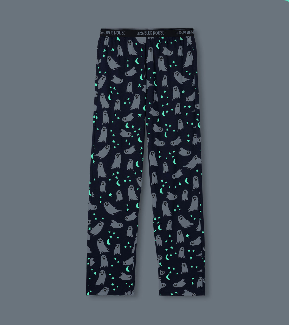 Men's navy ghost print pajama pants shown glowing in the dark with bright stars and crescent moons
