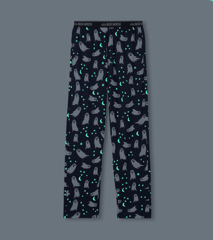 Men's navy ghost print pajama pants shown glowing in the dark with bright stars and crescent moons