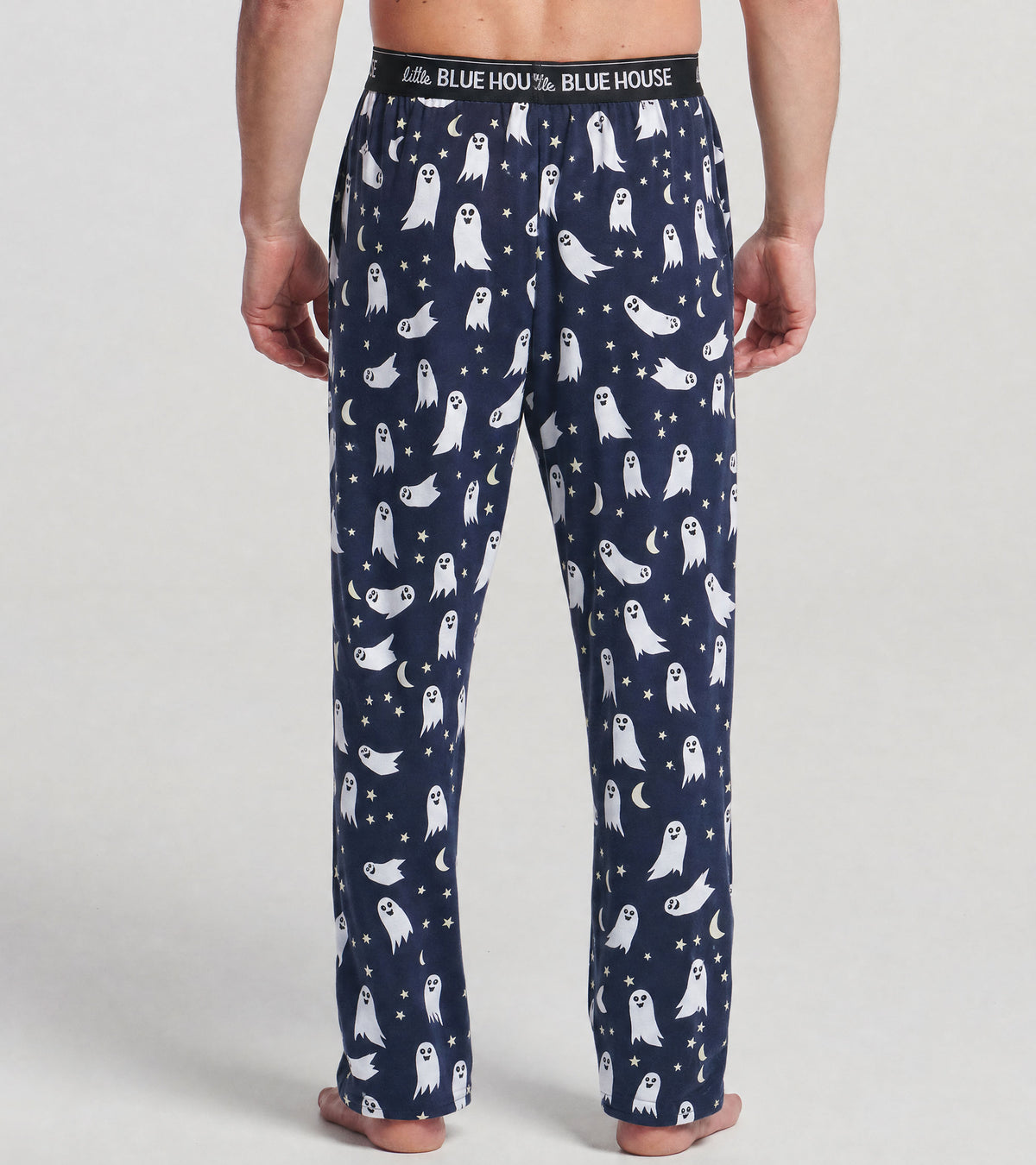 Back view of men's navy pajama pants with white ghosts, stars and crescent moons, and logo waistband