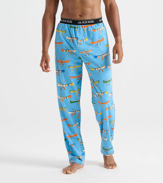 Front view of men's blue pajama pants with colorful canoe and crossed paddle print and black logo waistband