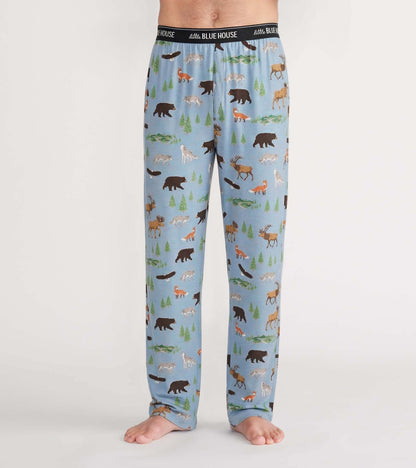 Front view of light blue pajama pants with bears, moose, foxes, wolves, trees, and little Blue House waistband