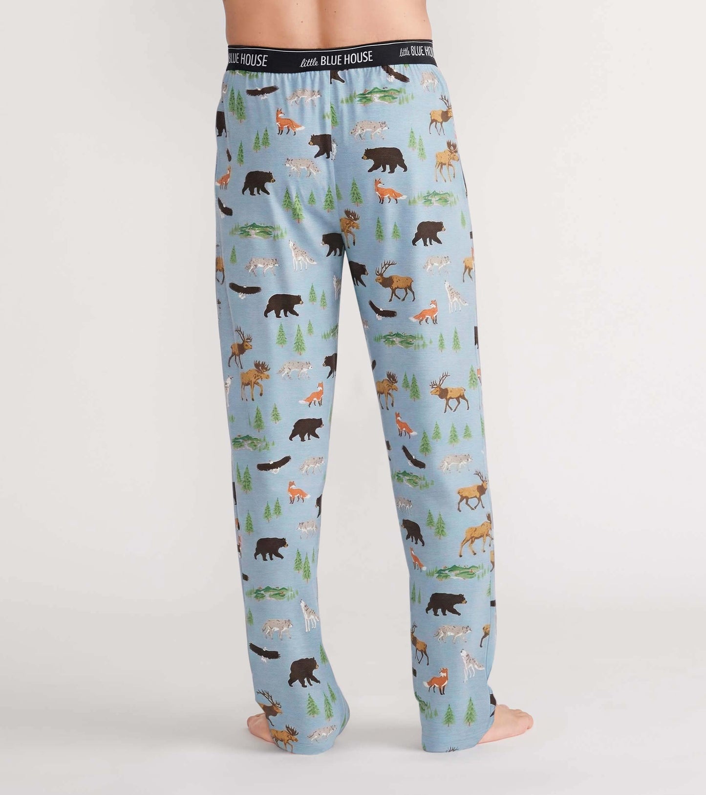 Back view of light blue pajama pants with bears, moose, foxes, wolves, and evergreen tree print