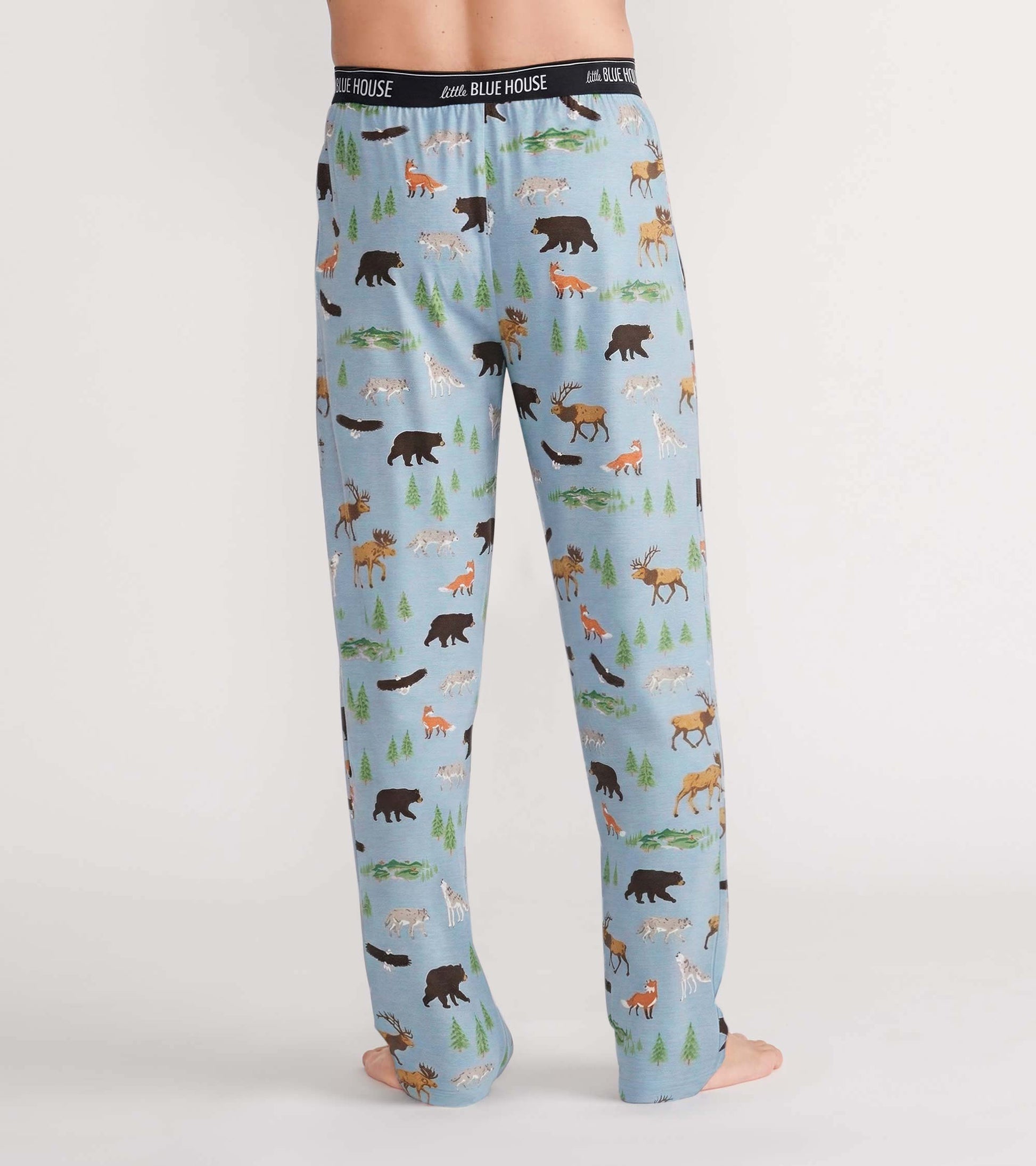 Back view of light blue pajama pants with bears, moose, foxes, wolves, and evergreen tree print