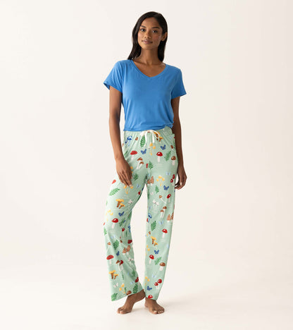 Model wearing mint green mushroom-print pajama pants with a blue V-neck T-shirt, front view.