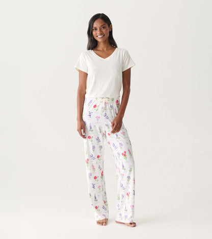 White women’s pajama pants with colorful wildflower print, straight-leg fit, shown on model