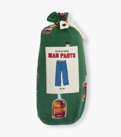 Green pajama pants with bourbon bottle print, shown folded and tied with a white ribbon.